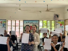 Students proudly holding up their hand-drawn constellation patterns during the Durbin workshop at Moneshwar Government Primary School.