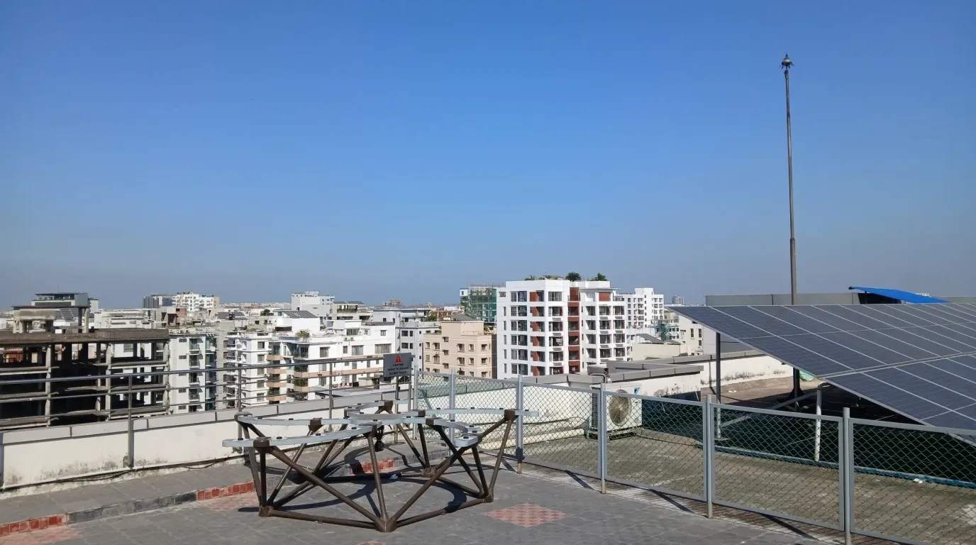 The TART radio telescope array on the rooftop of IUB's academic building, with the Dhaka skyline behind it